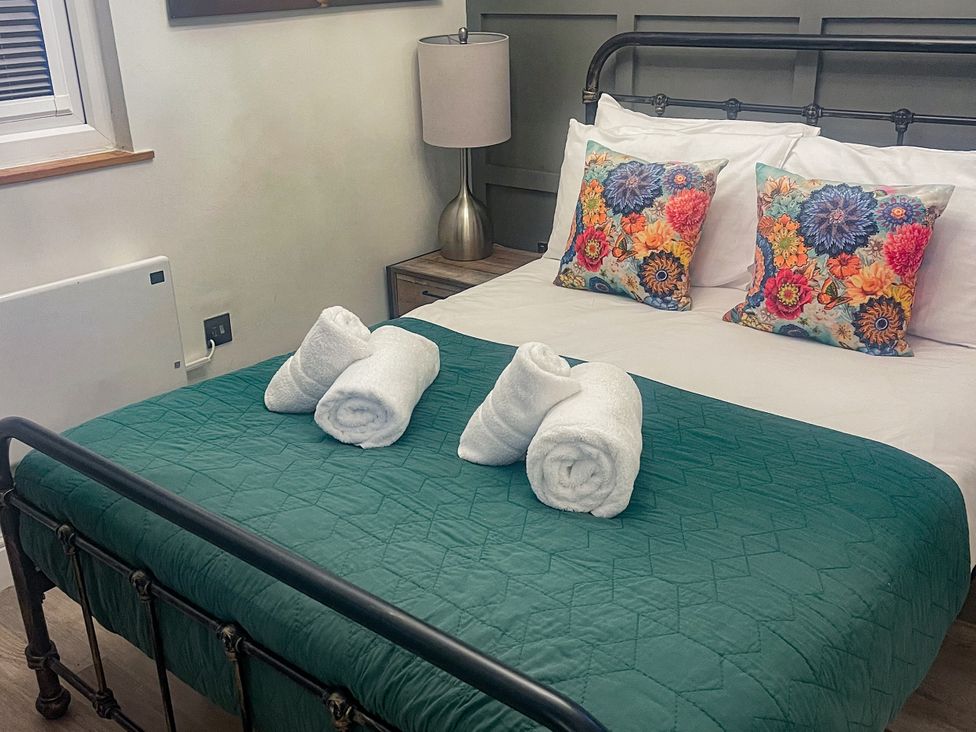 A bedroom with a bed and decorative pillows at Woodburn Lodge Otterburn