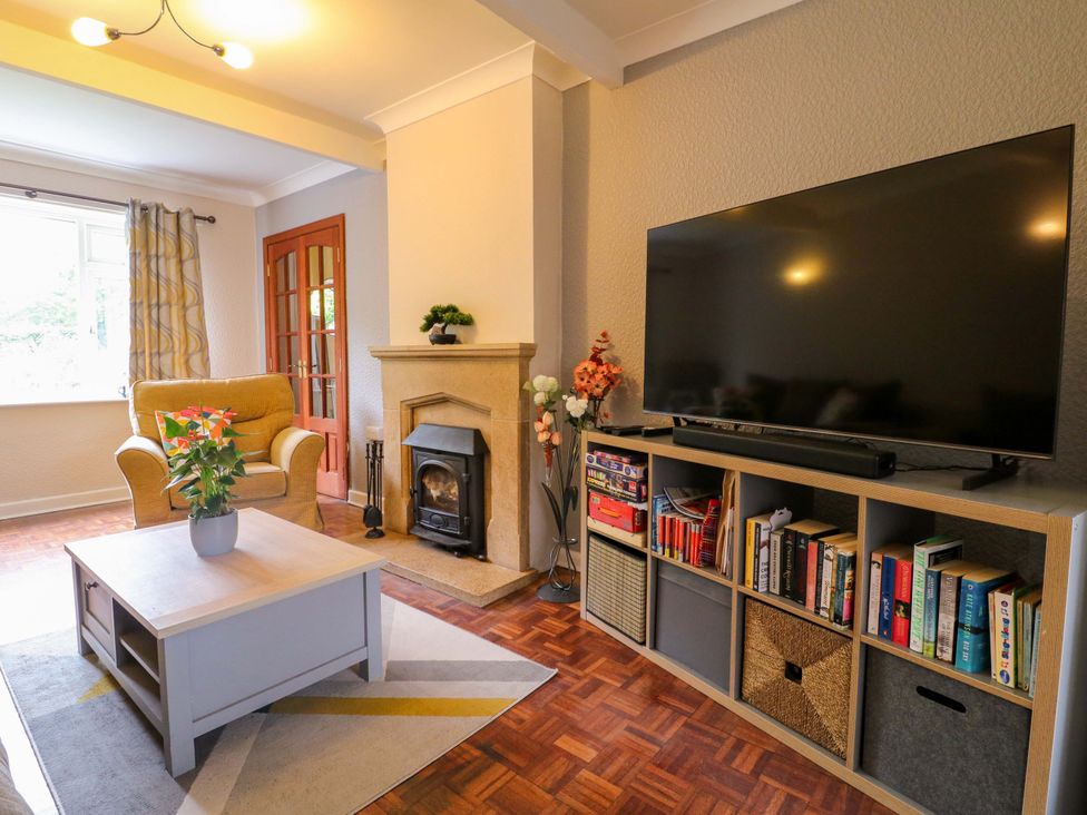 A living room with an armchair and television at Oxcroft View in Oxcroft near Clowne