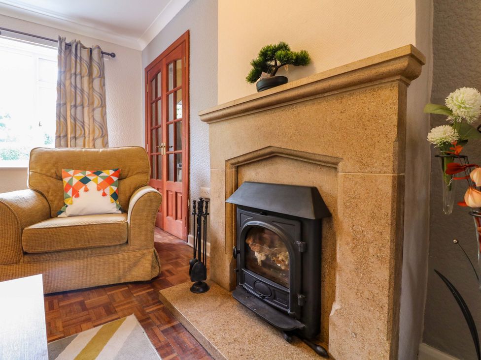 A living room with an armchair and fireplace at Oxcroft View in Oxcroft near Clowne