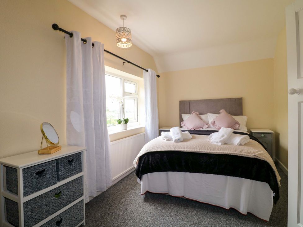 A bedroom with a bed and window at Oxcroft View near Clowne