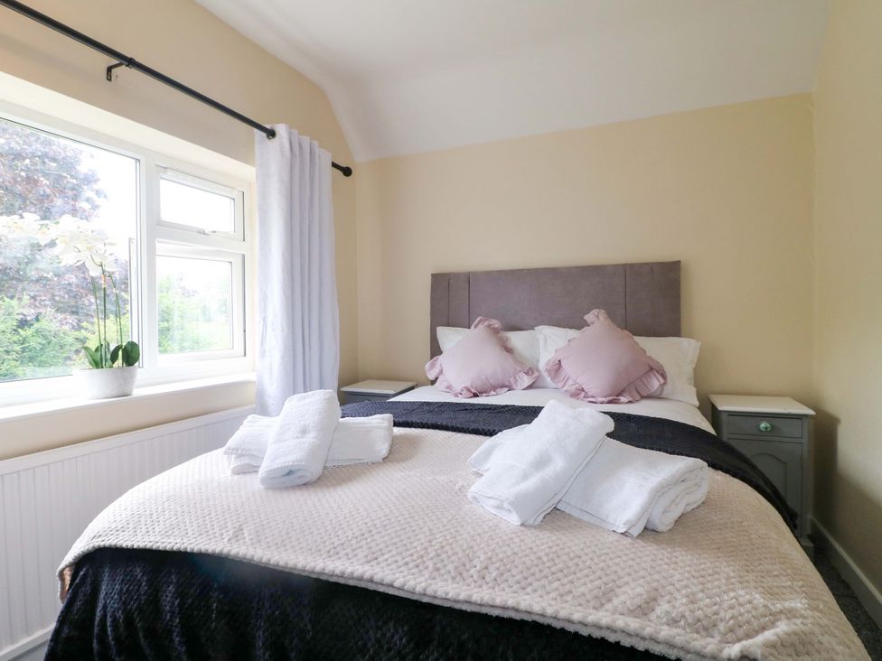 A bedroom with a bed and a window at Oxcroft View near Clowne