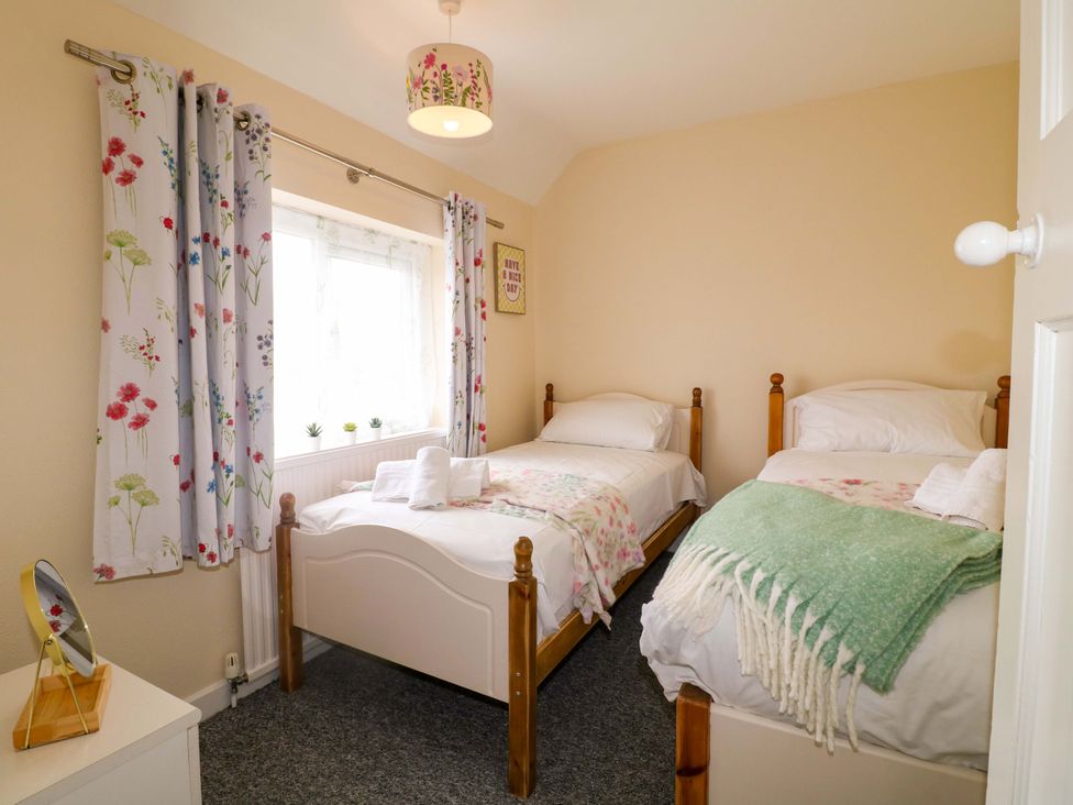 A bedroom with two beds and a window at Oxcroft View in Oxcroft near Clowne