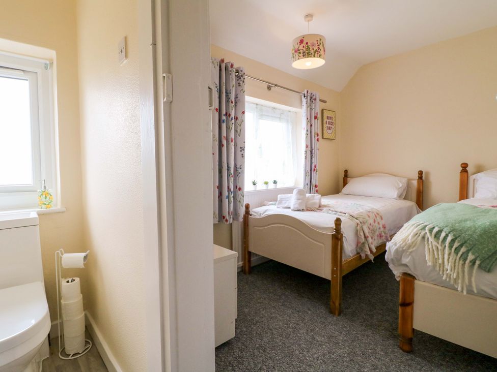 A bedroom with two beds and a window at Oxcroft View in Oxcroft near Clowne