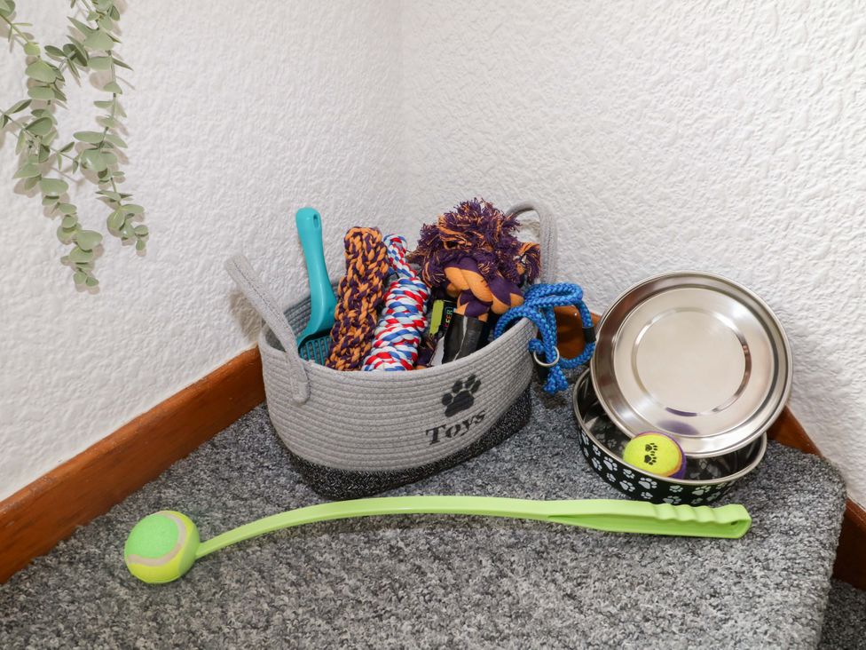 A basket with dog toys and bowls at Oxcroft View in Oxcroft near Clowne