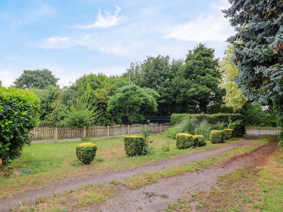 A garden with trees and a pathway at Oxcroft View in Oxcroft near Clowne