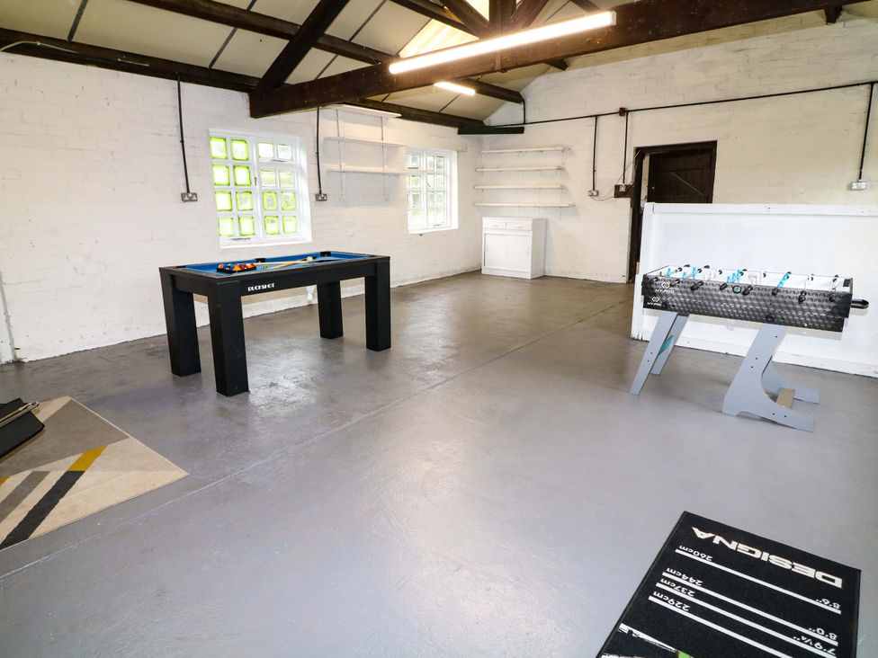A game room with a pool table and foosball table at Oxcroft View in Oxcroft near Bolsover