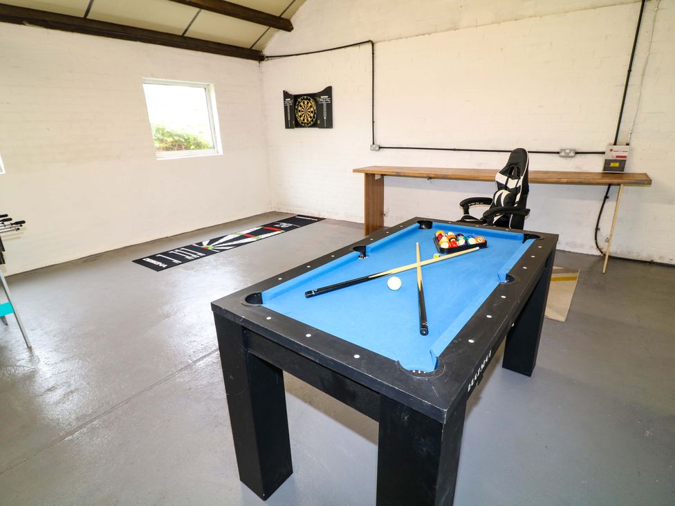 A game room with a pool table and dartboard at Oxcroft View near Bolsover