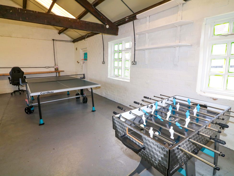 A games room with a table tennis table and a foosball table at Oxcroft View Oxcroft near Bolsover