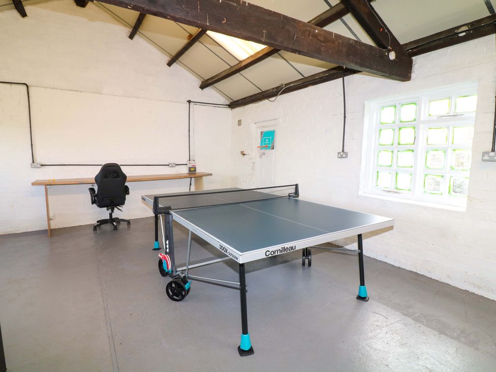 A game room with a table tennis table and desk at Oxcroft View near Bolsover