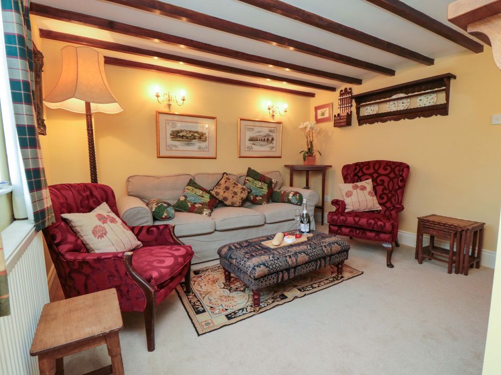 A snug with a sofa and armchairs at Spring Cottage in York