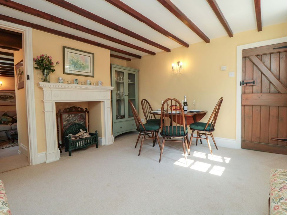 A dining room with a table and chairs at Spring Cottage in York