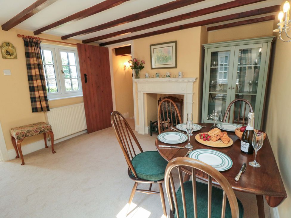 A dining room with a table set for a meal at Spring Cottage in York