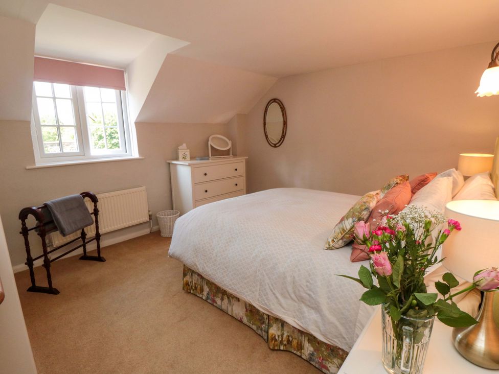 A bedroom with a bed and dresser at Spring Cottage in York