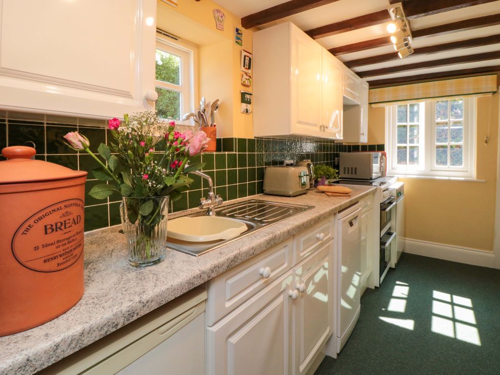 A kitchen with sink and appliances at Spring Cottage in Husthwaite