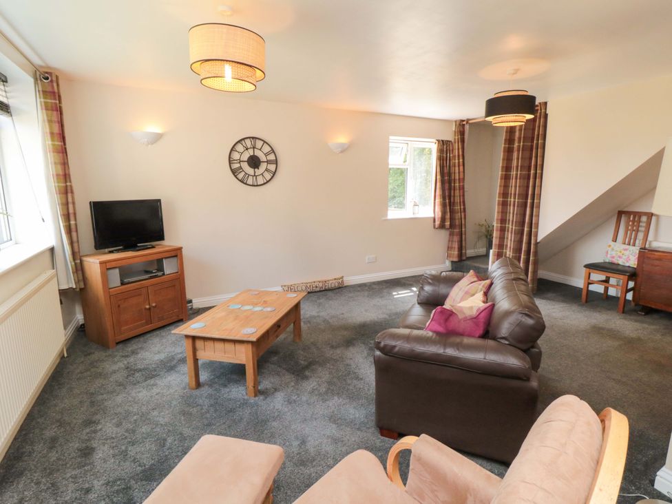 A living room with a television and seating area at The Annex in York