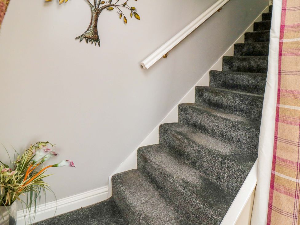 A staircase with a handrail and wall art at The Annex in York