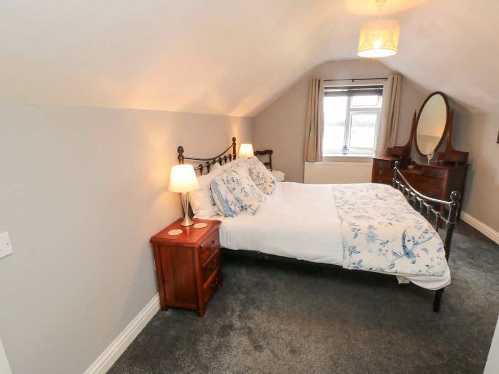 A bedroom with a bed and bedside table at The Annex in York