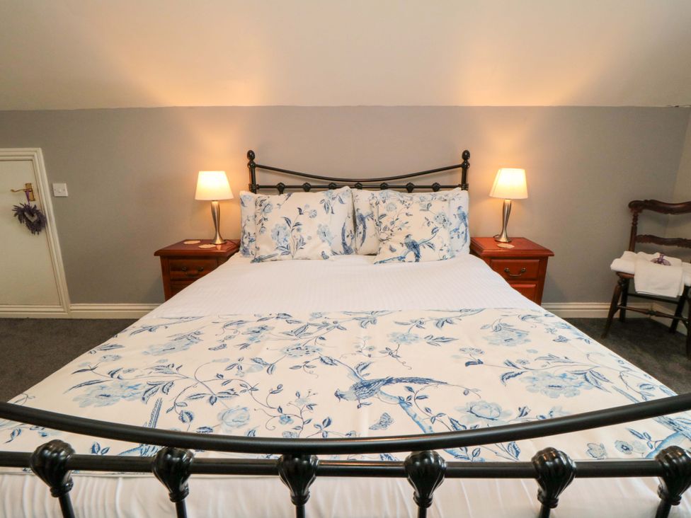 A bedroom with a bed and bedside tables at The Annex in York