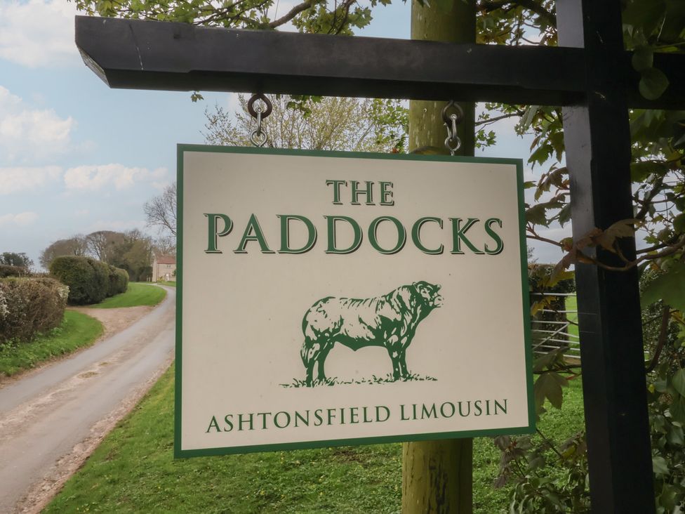 A sign for The Paddocks and Ashtonsfield Limousin near a road