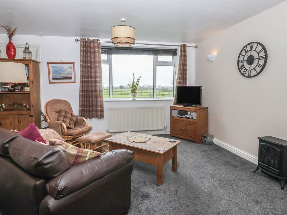 A living room with a sofa and coffee table at Walnut Cottage in Helmsley