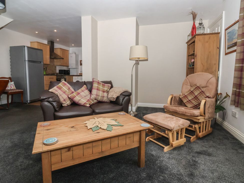 A living room with a sofa and coffee table at Walnut Cottage in Helmsley