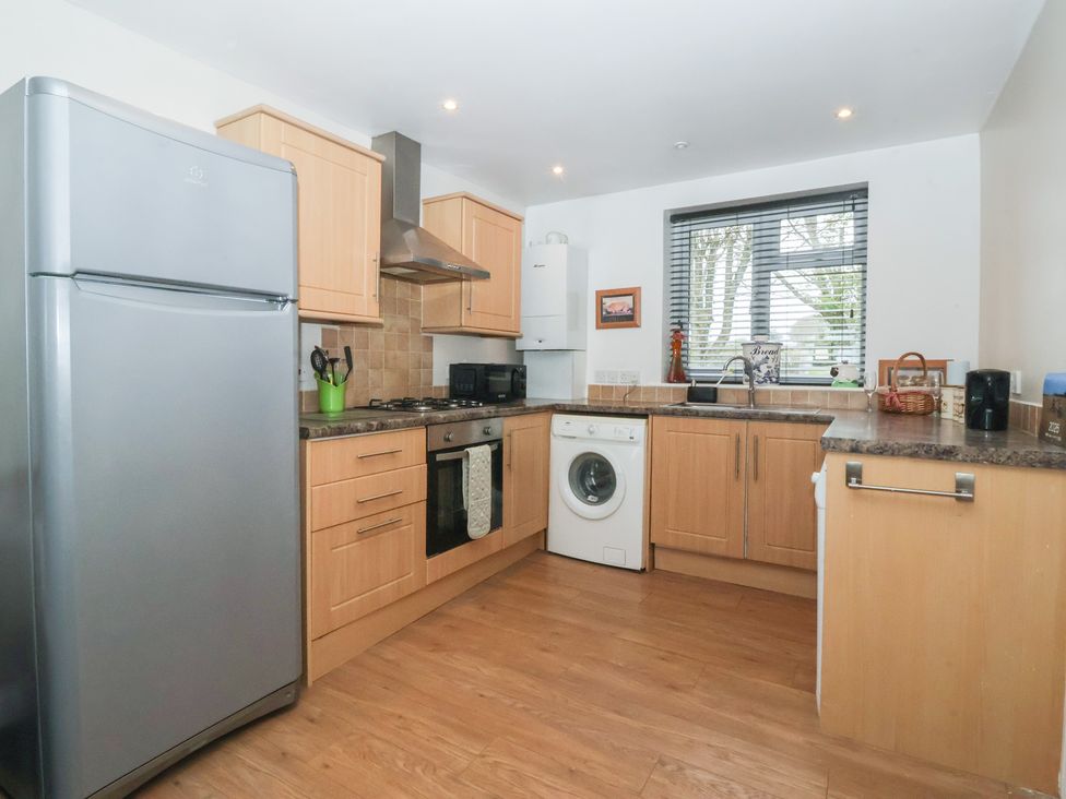 A kitchen with appliances and cabinets at Walnut Cottage in Helmsley