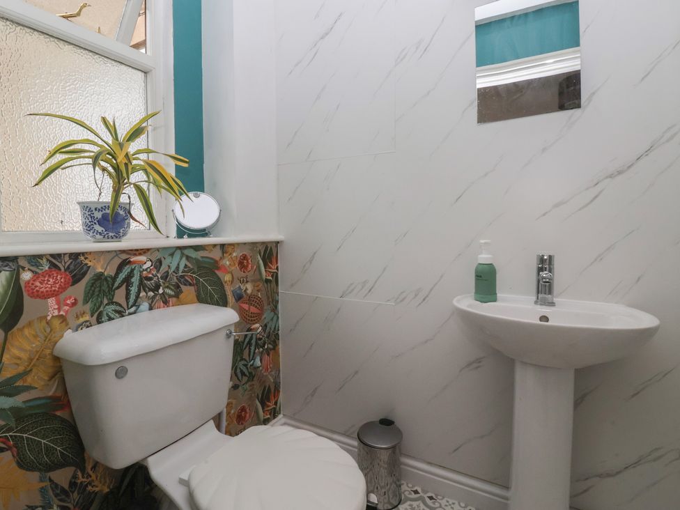 A bathroom with a toilet and sink at Walnut Cottage Helmsley