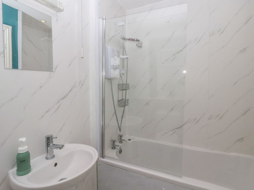 A bathroom with a sink and shower at Walnut Cottage in Helmsley