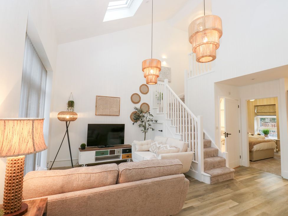 A living room with a sofa and television at 12 River View, Keighley