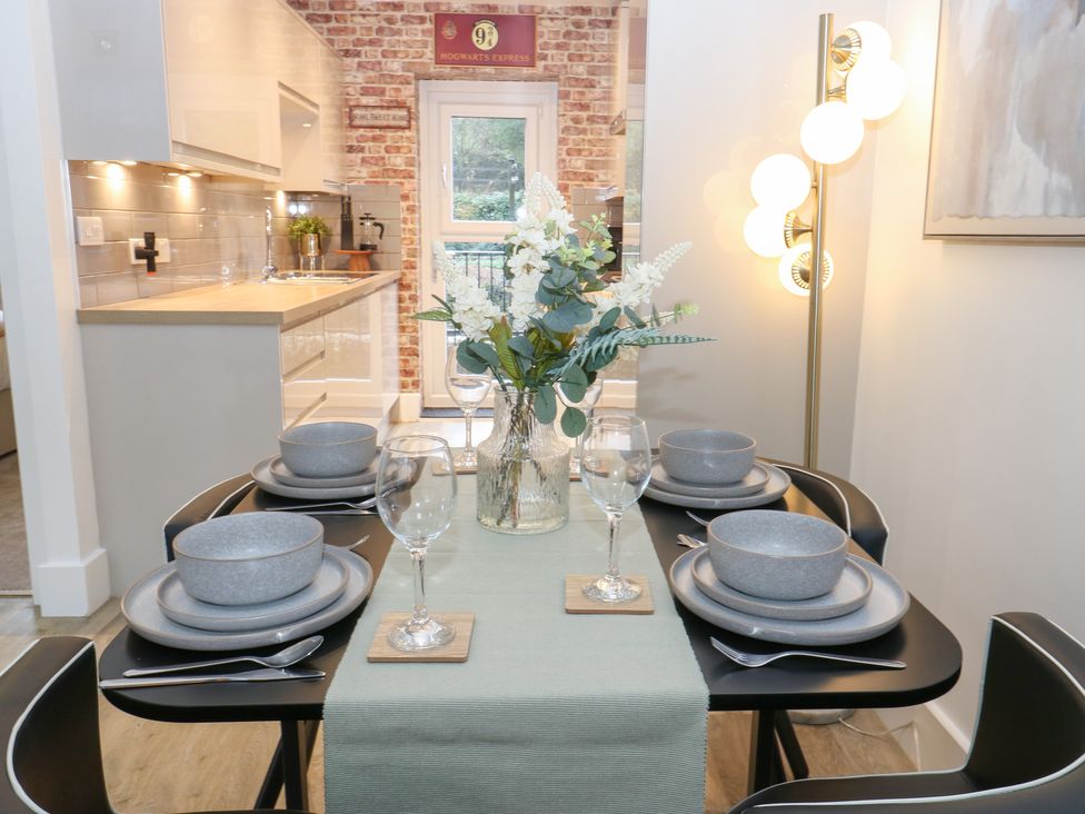 A dining table set with plates and glasses at 12 River View, Keighley