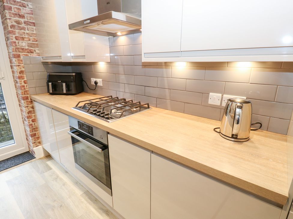 A kitchen with a gas stove and oven at 12 River View in Keighley