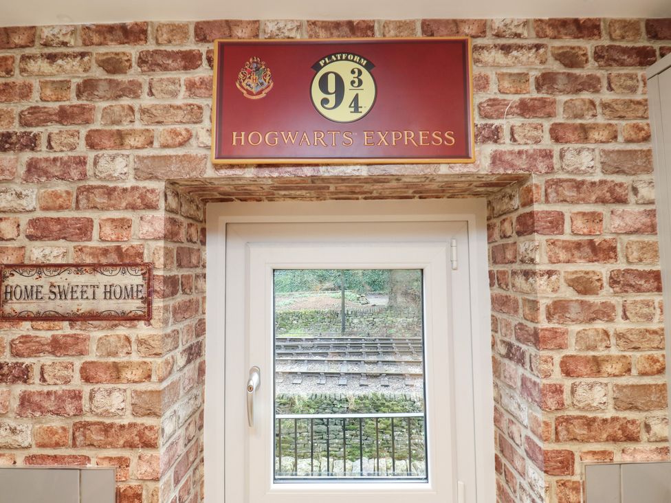 A window with a sign and brick wall at 12 River View Keighley