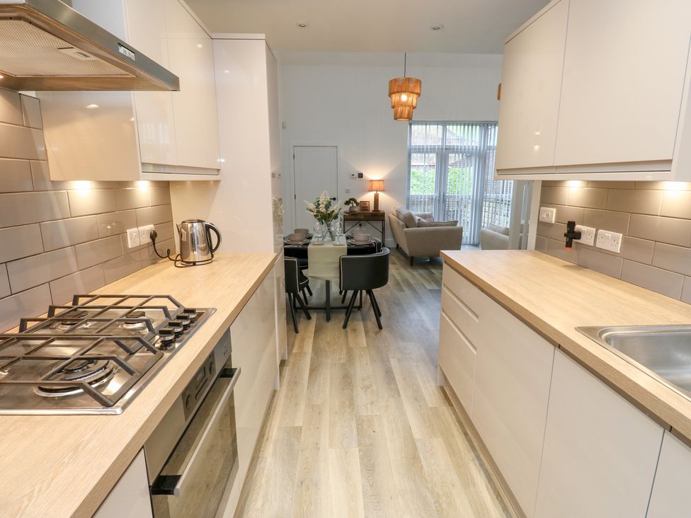 A kitchen with stove and dining area at 12 River View Keighley