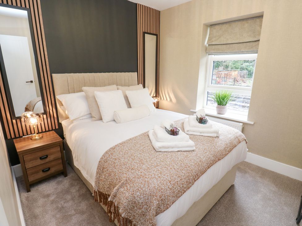 A bedroom with a bed and nightstand at 12 River View Keighley