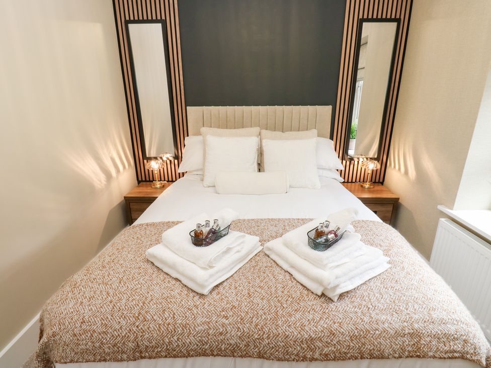 A bedroom with a bed and decorative items at 12 River View in Keighley