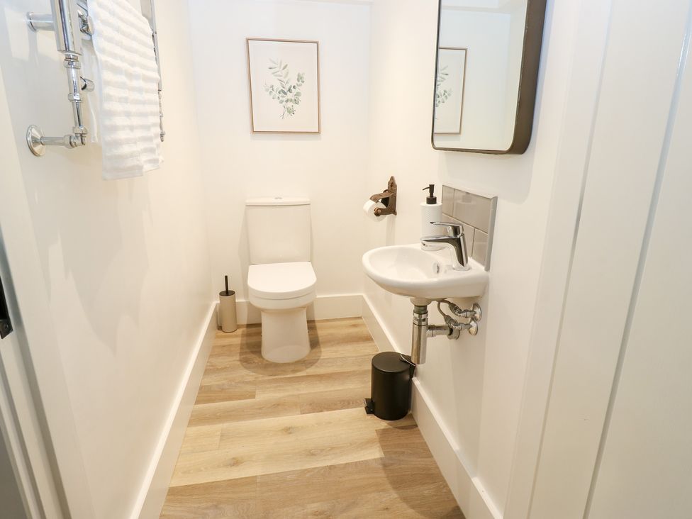A bathroom with a toilet and sink at 12 River View, Keighley