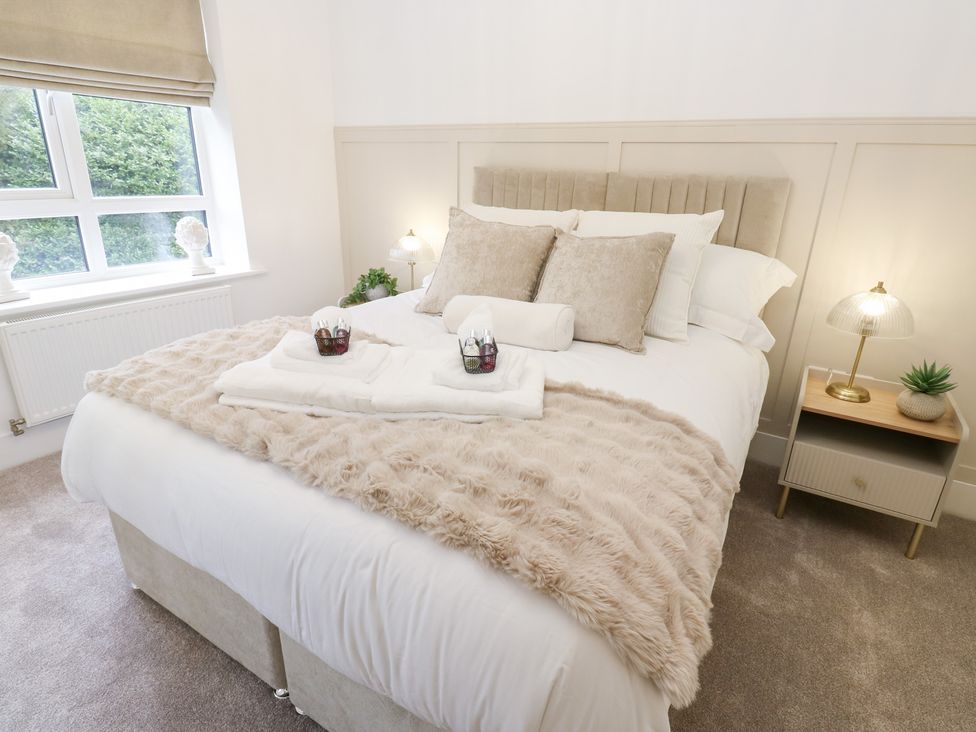 A bedroom with a bed and nightstand at 12 River View in Keighley