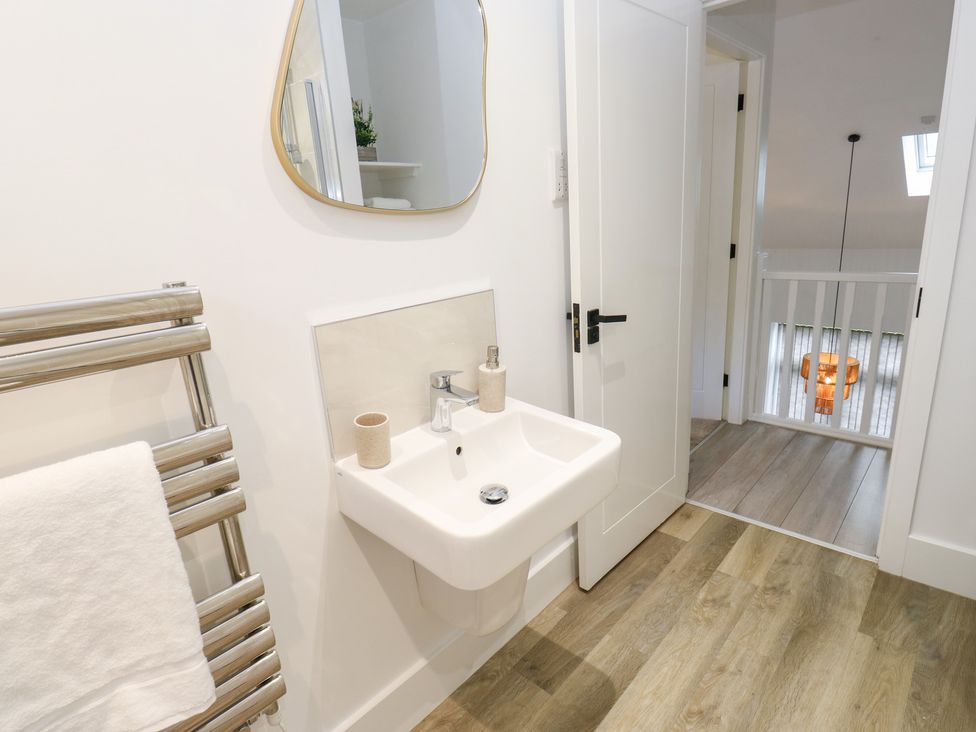 A bathroom with a sink and mirror at 12 River View in Keighley