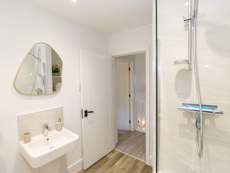 A bathroom with sink and shower at 12 River View in Keighley