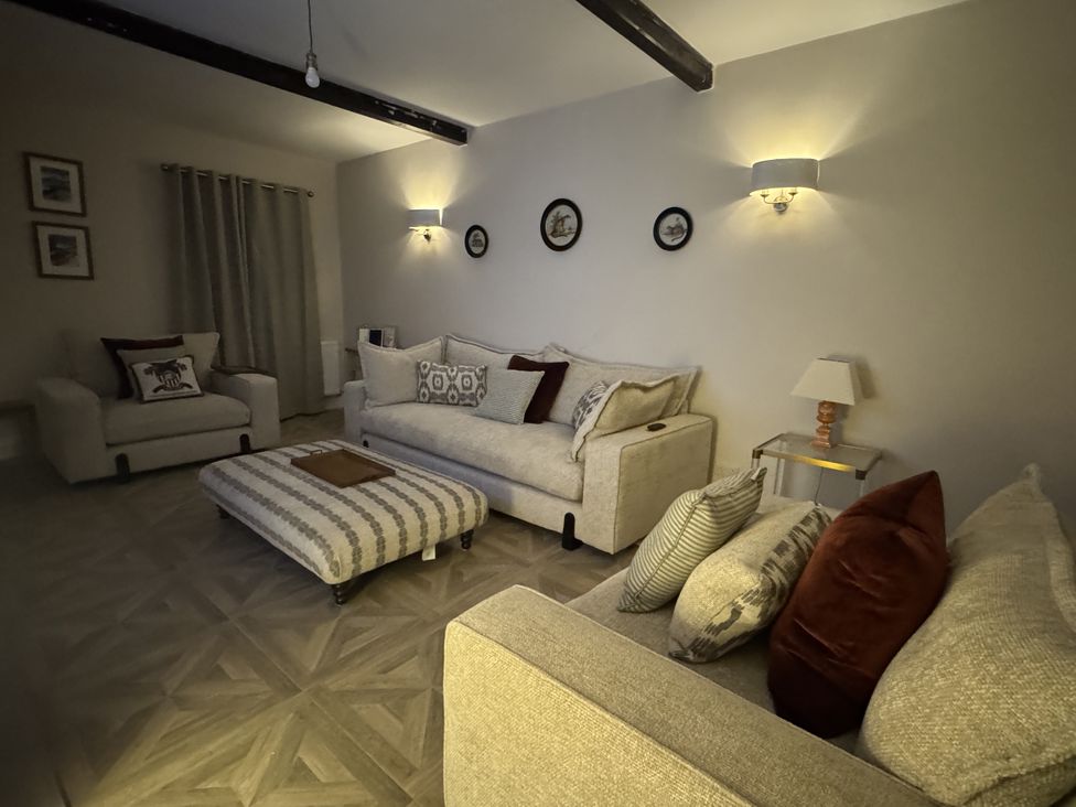 A living room with sofas and a coffee table at Yew Tree Cottage