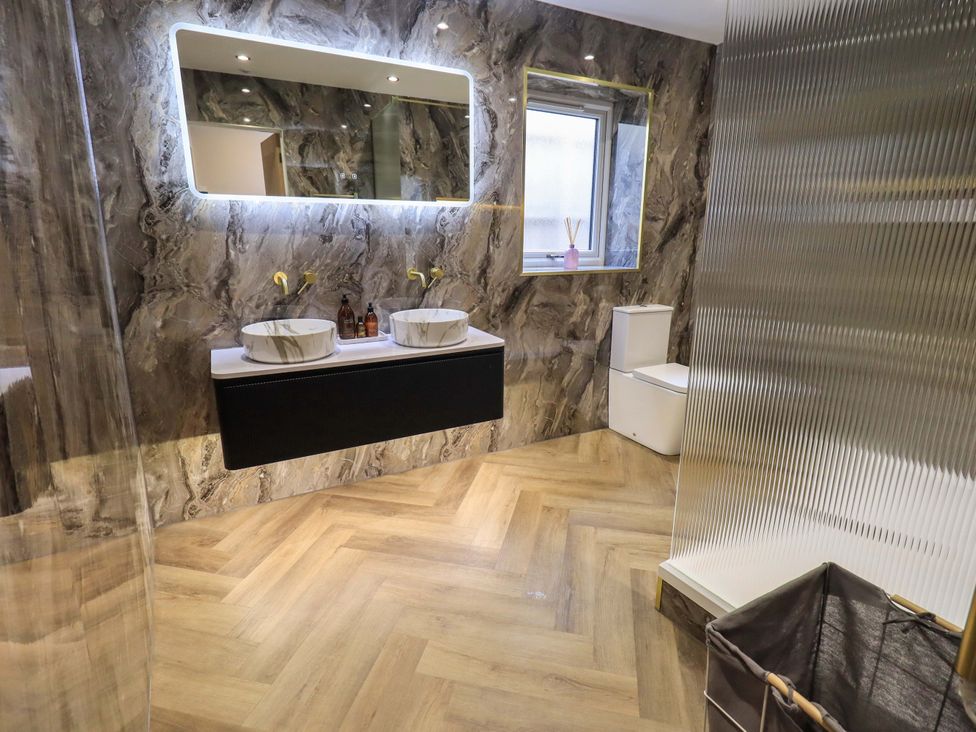 A bathroom with a sink and toilet at Yew Tree Cottage Mealsgate near Ireby