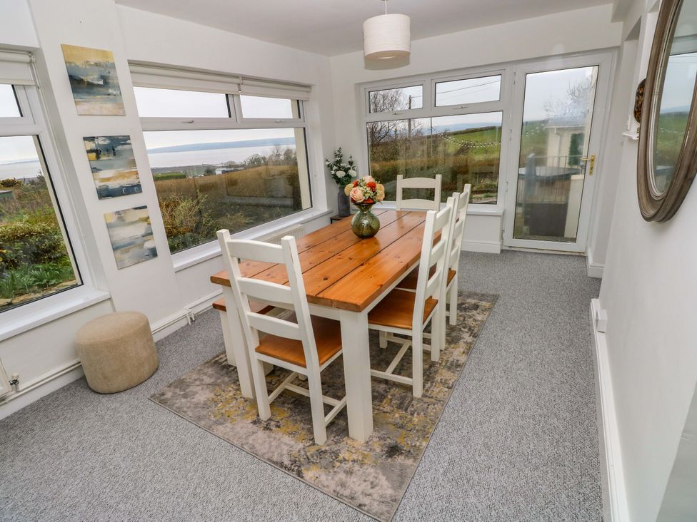 A dining room with a table and chairs at Burry House in Llanmorlais