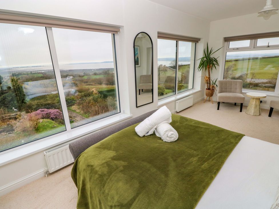 A bedroom with a bed and a plant at Burry House in Llanmorlais