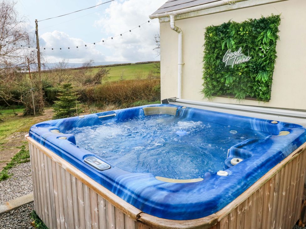 A hot tub in a garden at Burry House Llanmorlais