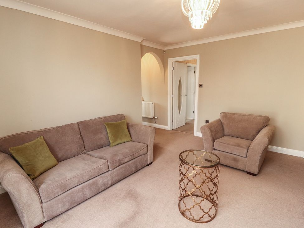 A living room with a sofa and coffee table at 3 Hawk Place Moresby Parks near Whitehaven