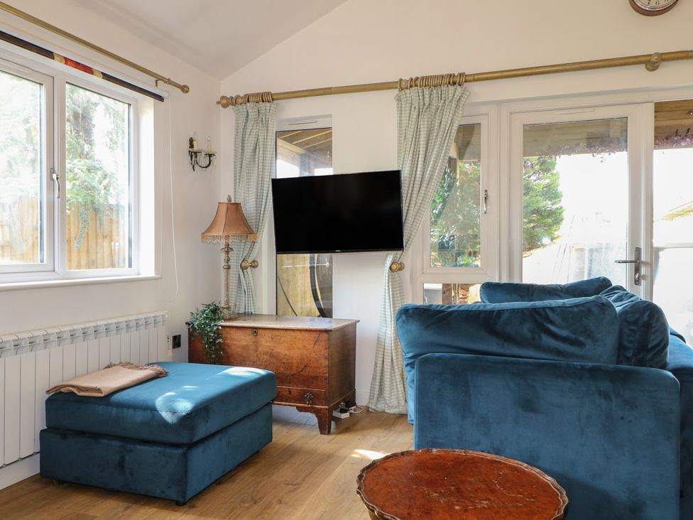 A snug with a sofa, television and table at El -Nido Alton