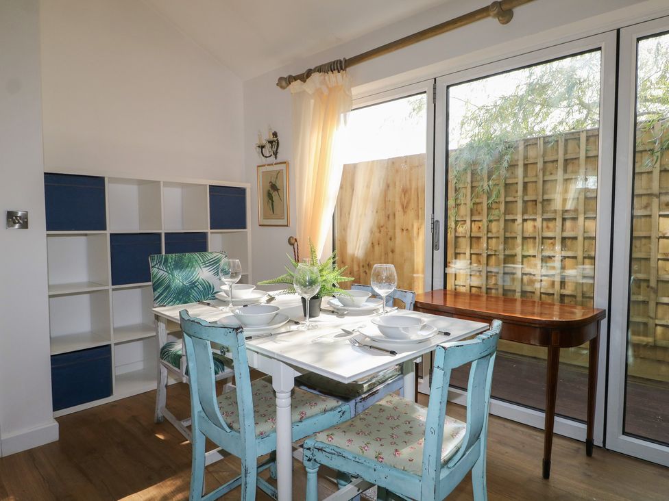A dining room with a table set for meals at El -Nido in Alton