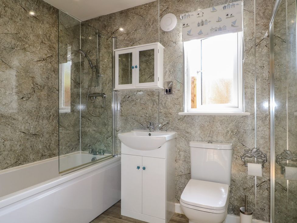 A bathroom featuring a bathtub, shower, sink, and toilet at El -Nido in Alton