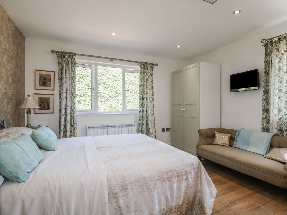 A bedroom with a bed, sofa, and cabinet at El -Nido in Alton