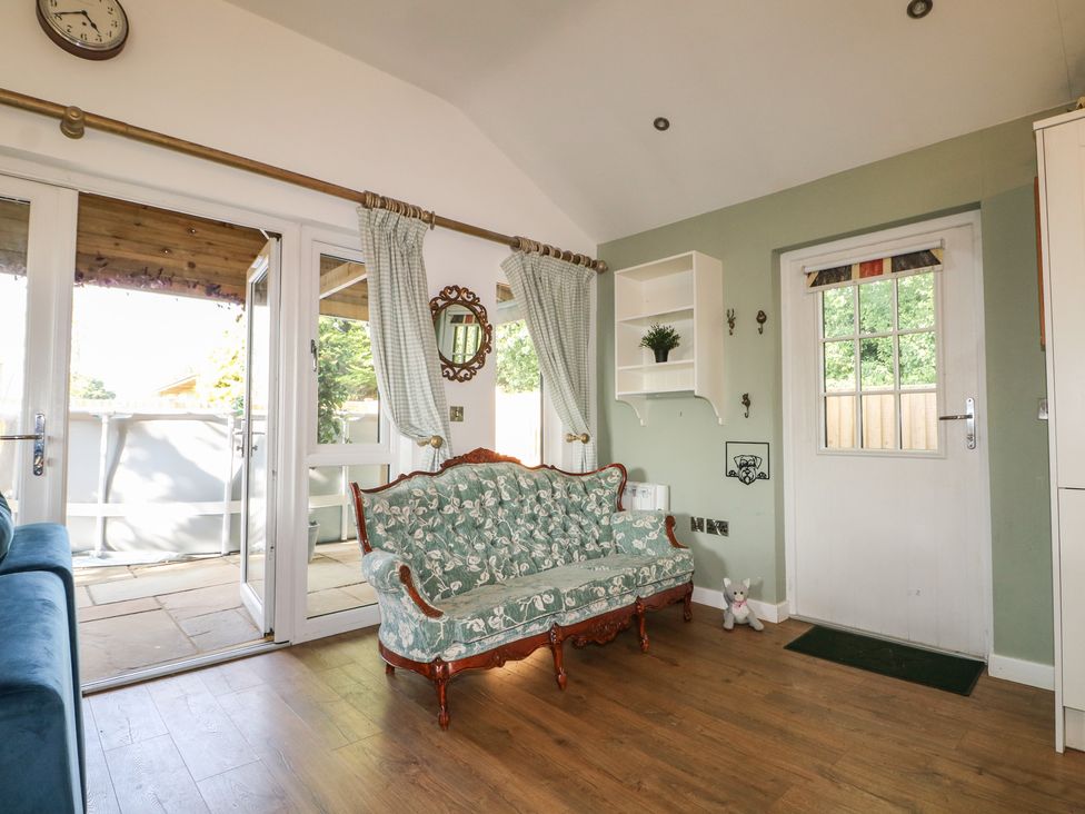 A sitting area with a sofa and door at El -Nido Alton